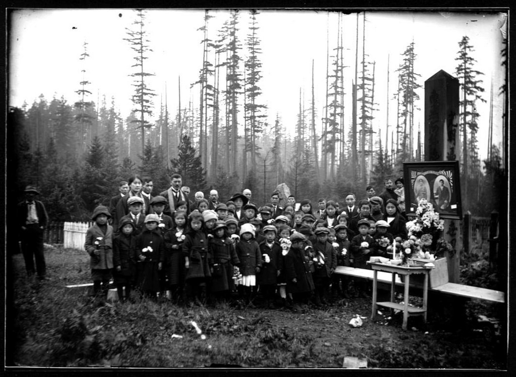 Memorial service for solider killed in WWI for Canada. An altar is erected in the cemetery. Portrait on left shows man in WWI British/ Canadian uniform. Statement written below states: "roll of honour 1914-1918."(C140-003 Cumberland Museum and Archives)